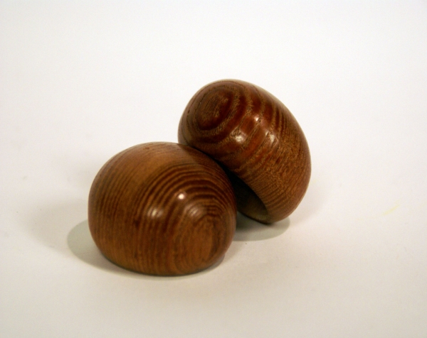Custom wood turnings made into two stained wood caps